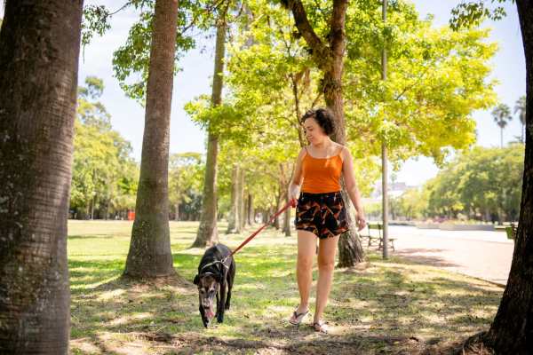 Resident woman with a dog in a nearby dog park at Whitmore in Houston, Texas
