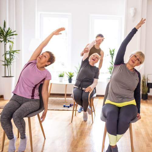 Trainer supporting a residents through a fitness session at The Residences at Thomas Circle in Washington, District of Columbia 