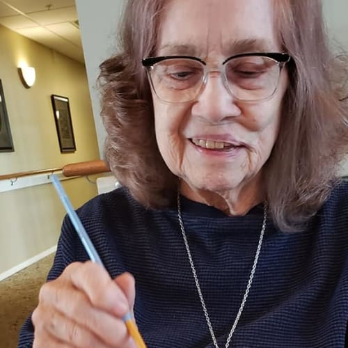 A resident at doing arts and crafts Canoe Brook Assisted Living & Memory Care in Catoosa, Oklahoma