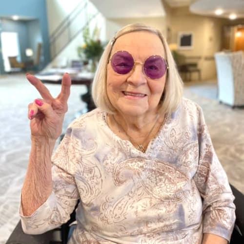 Resident peace sign at The Oxford Grand Assisted Living & Memory Care in McKinney, Texas