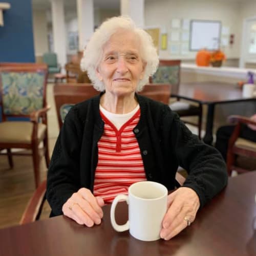 Resident with coffee at Madison House in Norfolk, Nebraska 