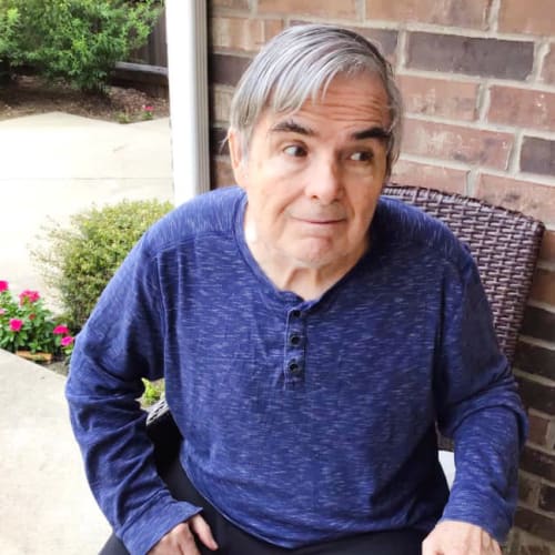 A resident looking off camera at Oxford Glen Memory Care at Grand Prairie in Grand Prairie, Texas