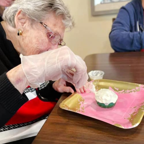 Resident making cupcakes at The Oxford Grand Assisted Living & Memory Care in McKinney, Texas