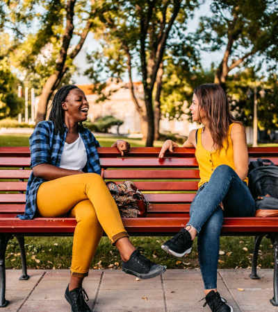 Residents sitting on a bench and talking in a park near Isles at East Millenia in Orlando, Florida