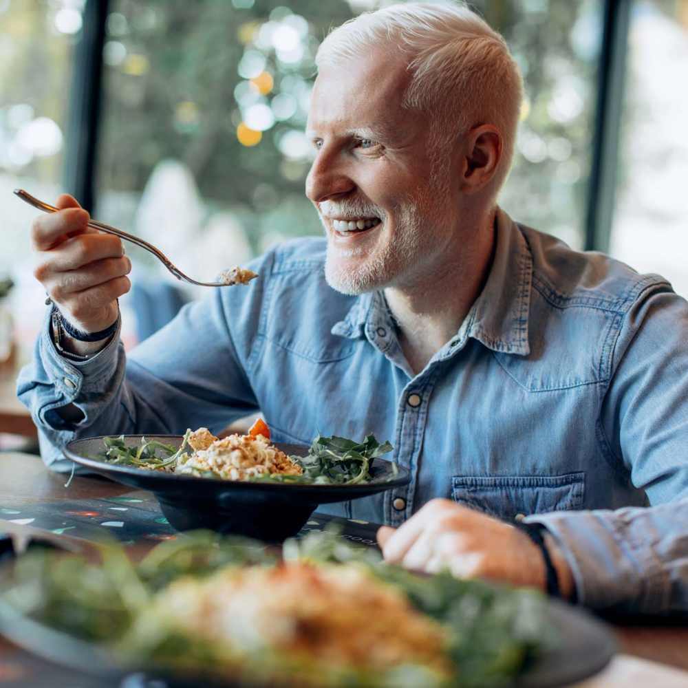 Resident enjoying food at his favorite restaurant near Mill Pond Apartments (Buchanan) in Buchanan, Michigan