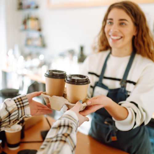 Resident woman buying coffee in a cafe near Crystal Lake Apartments in Crystal Lake, Illinois