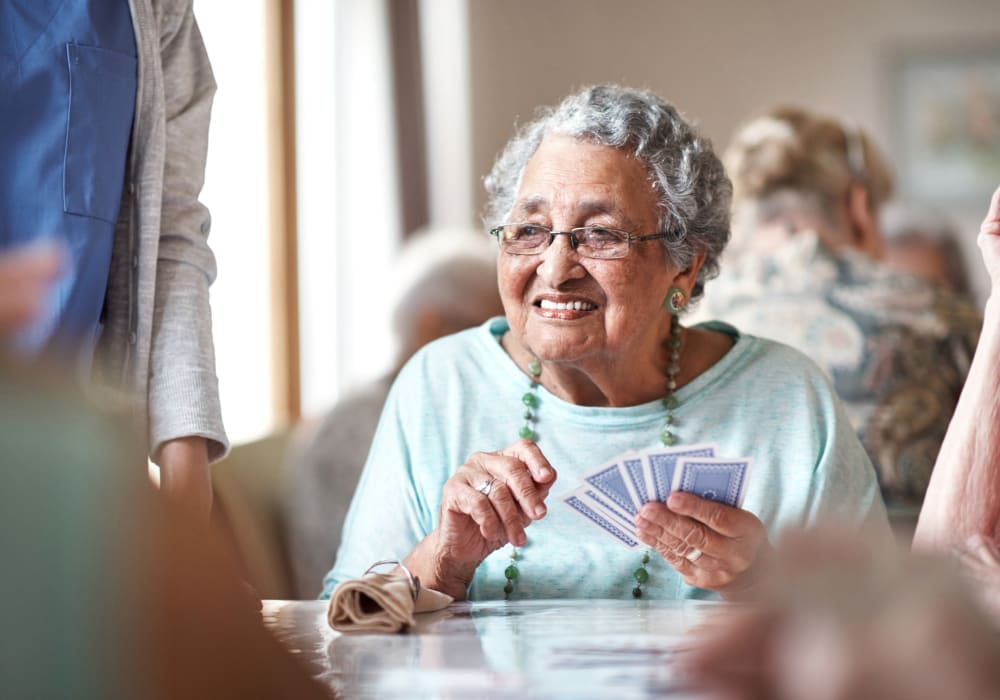 Resident playing cards at Autumn Grove Cottage at The Heights in Houston, Texas