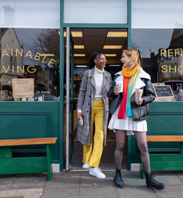 Two women walking out of a shop near The Station at Clift Farm in Madison, Alabama