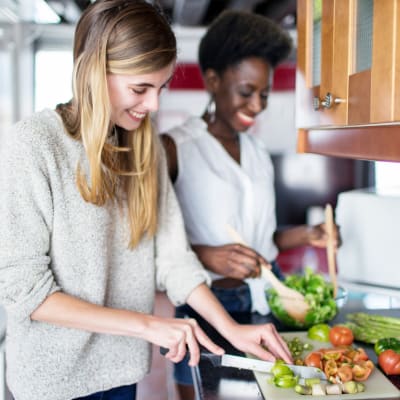 Friends are cooking in kitchen at Longshaw Road in Annapolis, Maryland