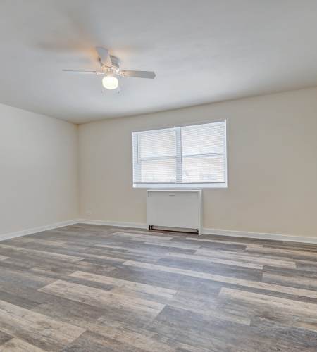 Spacious bedroom with large windows and air-conditioner at Chatham Grove Apartments in Chicago, Illinois