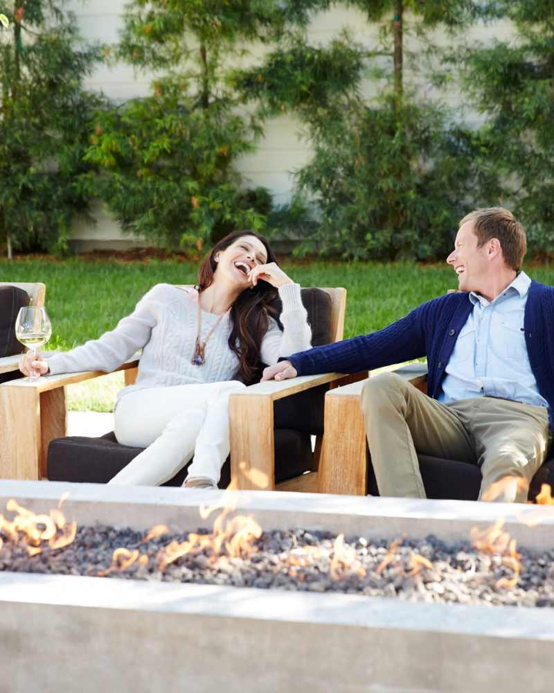Residents by a fire pit at the Mosaic