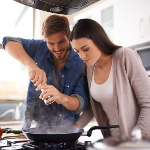 Happy couple cooking in kitchen at Davis Hill in Joint Base Lewis McChord, Washington