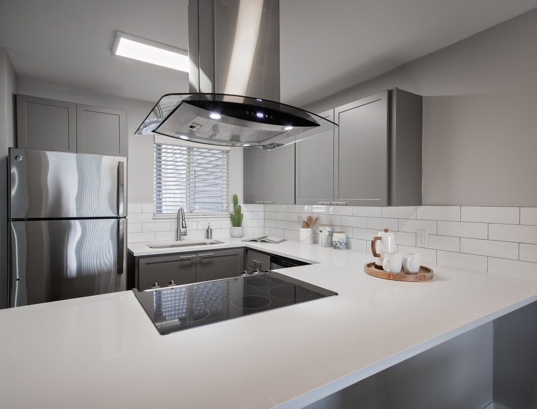 Ultramodern kitchen with stainless-steel appliances and subway tile backsplash in model home at MiLO at Mountain Park
