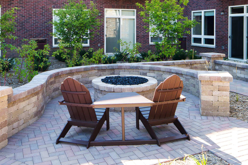 Outdoor fireplace with seating at Remington Cove Apartments in Apple Valley, Minnesota