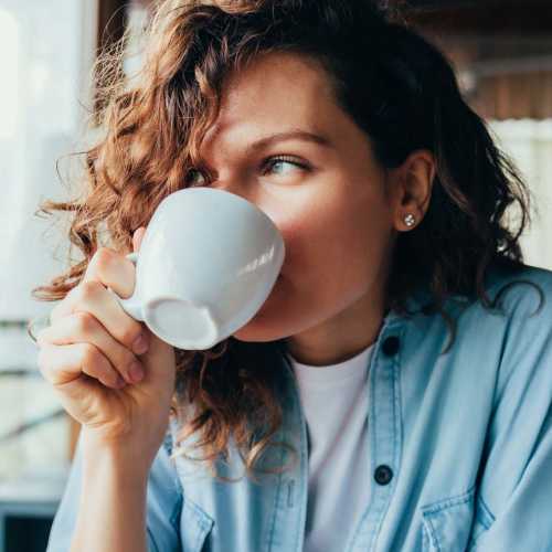 Woman having coffee near Warren Harbor in Indianapolis, Indiana