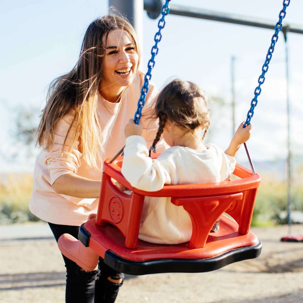 Resident mother and her child in a playground at One Belmar Place in Lakewood, Colorado