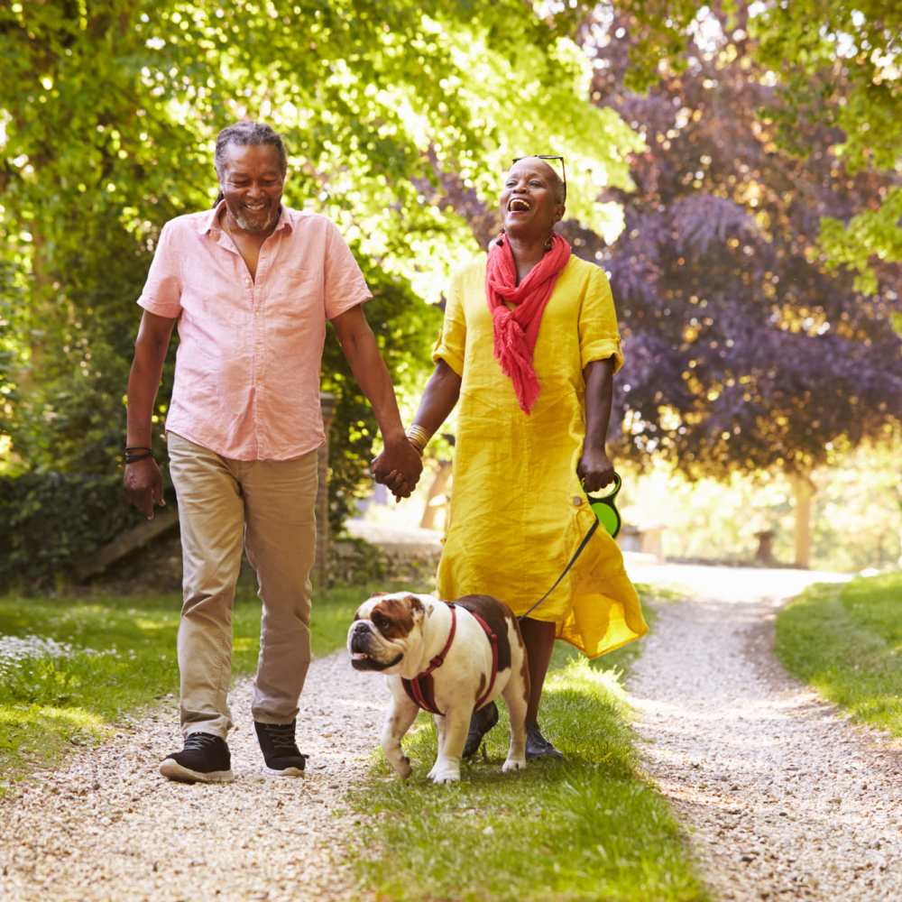 Resident couple walking along with pet dog at Cielo Azul in Palmdale, California