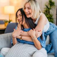 Residents sharing a warm moment together indoors at WaterWalk Kansas City - Overland Park in Overland Park, Kansas