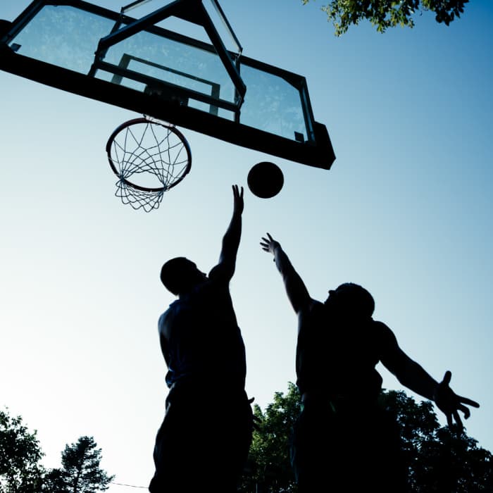 Residents playing basket ball at Copper Beech Town Homes in Clovis, California