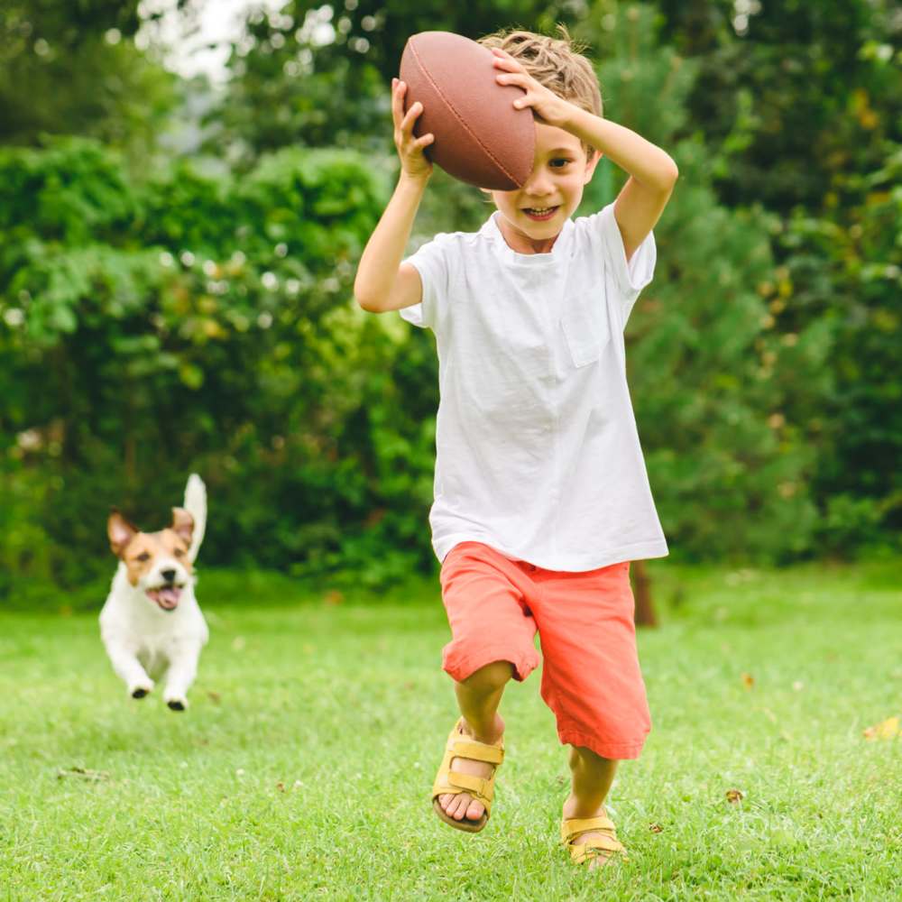 Kid playing with his pet in a park near Indian Terrace I Apartments in Auburn, Indiana
