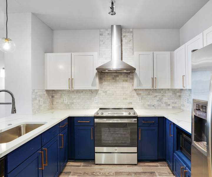 Modern kitchen with white cabinets at The Lofts At West 7th in Fort Worth, Texas