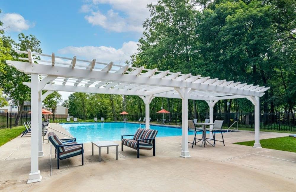Swimming pool surrounded by lounge chairs at Brookside Manor Apartments & Townhomes in Lansdale, Pennsylvania