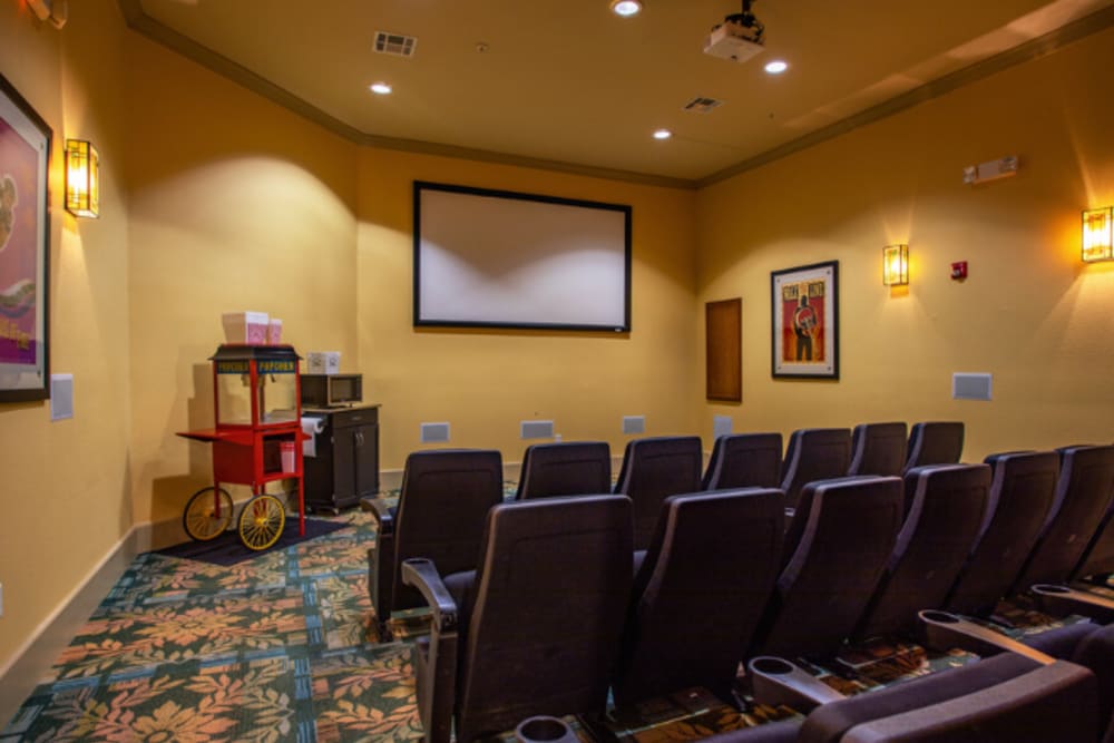 Seating in the community movie theater room at Mariposa at Ella Boulevard in Houston, Texas