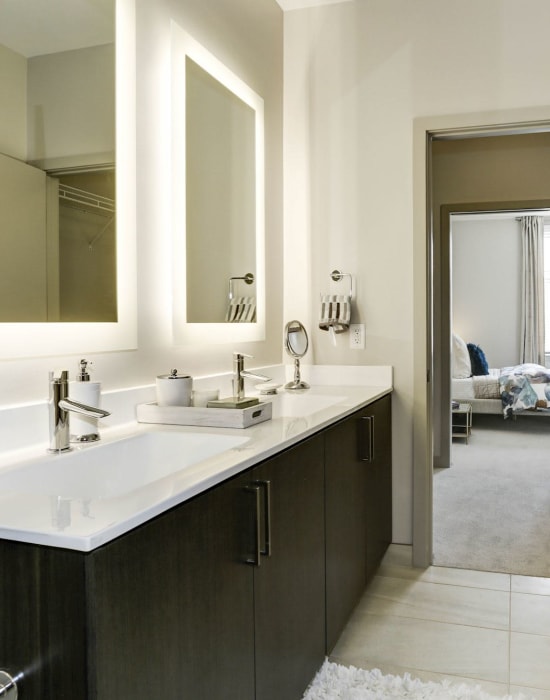 Bathroom with a large mirror and ample counter space at The Met Rockville in Rockville, Maryland