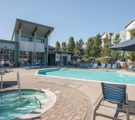 Pool tables and comfortable poolside seating at Azure Apartment Homes in Petaluma, California