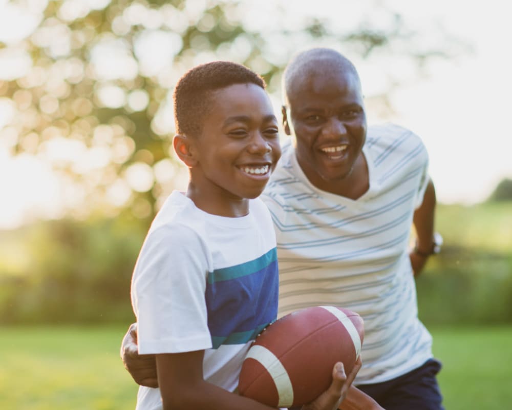 A resident and his son playing football at Admiral Hartman in San Diego, California