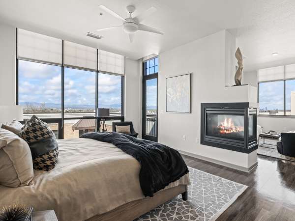 Stunning bedroom with fireplace at Kent Place Residences in Englewood, Colorado