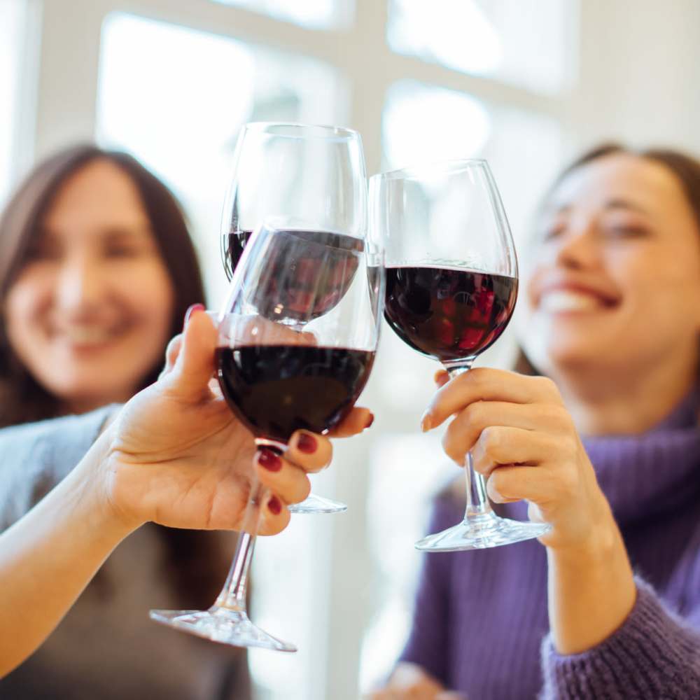 A group of friends clinking wine glasses at Bana At Tujunga in Tujunga, California