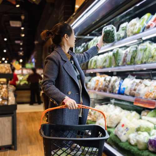 Resident woman shopping at a supermarket near 2202 Luann Place Apartments in Madison, Wisconsin