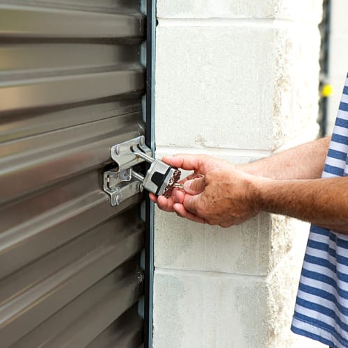 A customer unlocking his unit at Red Dot Storage in Kingwood, Texas