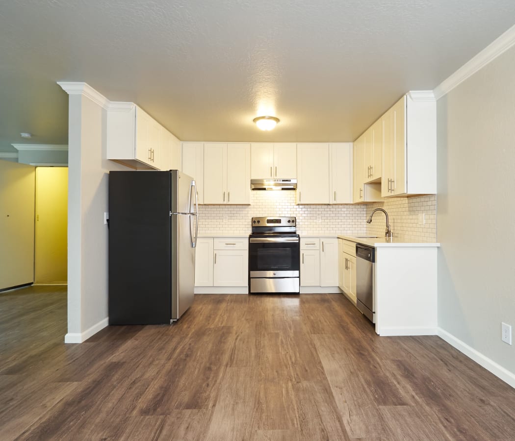 Beautiful kitchen with white cabinets and stainless-steel sink at Aptos Apartments in Aptos, California