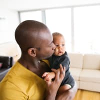 A father holding his young son at The Alexandria in Madison, Alabama