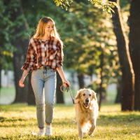 A woman walking her dog through a park near Gates at Jubilee in Daphne, Alabama