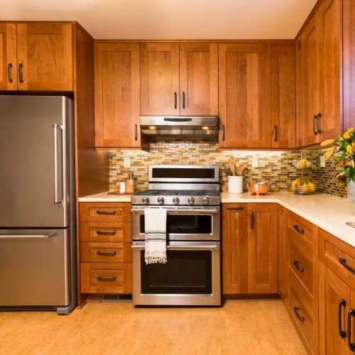 Stainless-steel appliances in a model home's kitchen at Olympus Court Apartments in Bakersfield, California