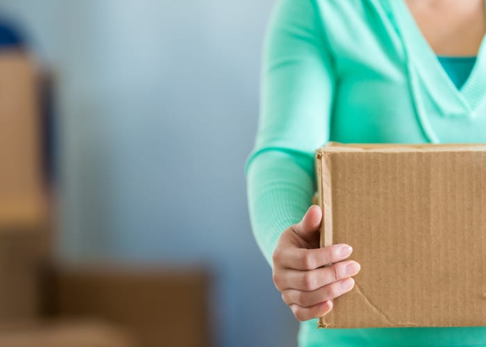 A woman holding a box at RC Storage in Des Moines, Iowa