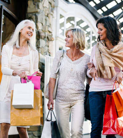 Residents carrying shopping bags near Athens Vista Senior Apartments in Los Angeles, California