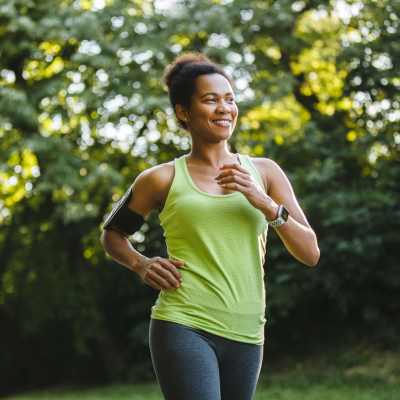 Resident jogging in a park, surrounded by greenery and trees near Greentree in Indianapolis, Indiana