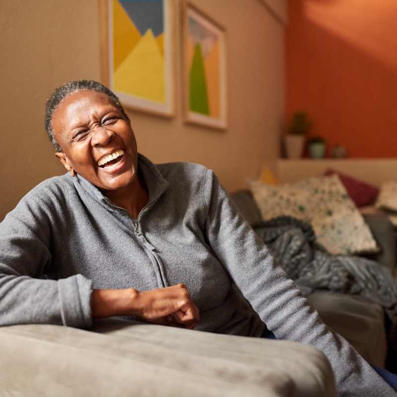 A resident sits on his sofa in an apartment at Commons on Potomac Square, Sterling, Virginia