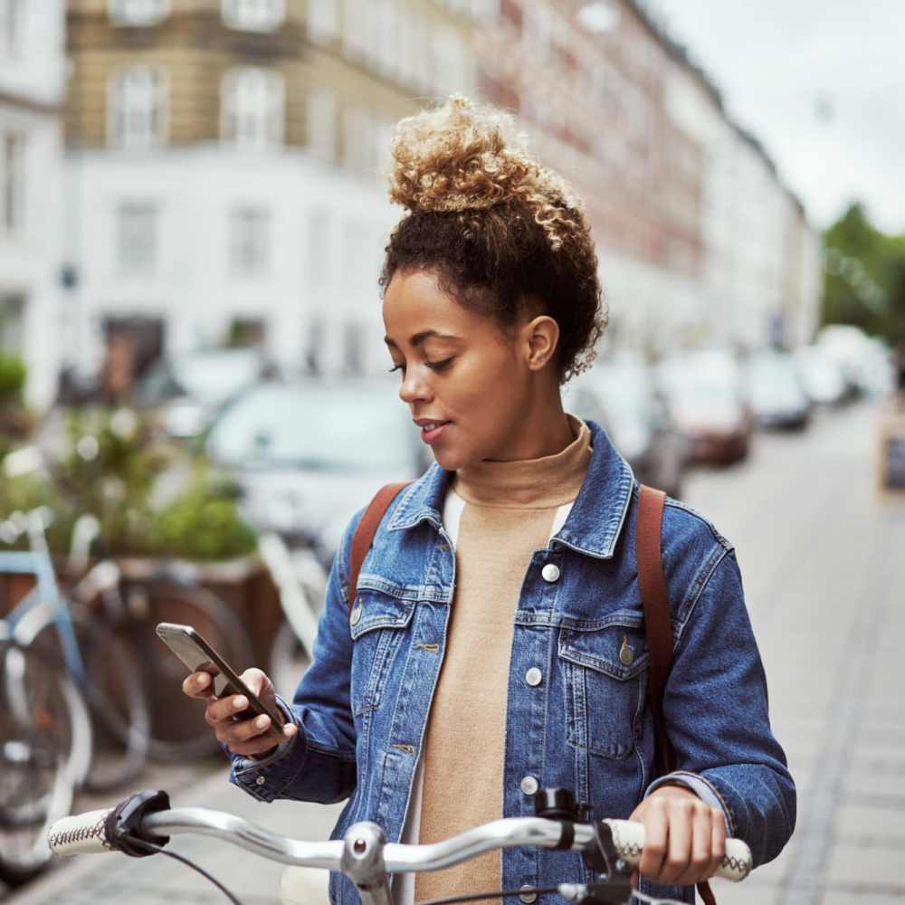 Resident using her phone on the streets at The Griff in Charlotte, North Carolina