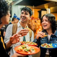 Residents toasting at a restaurant near The Linc in Rochester, New York