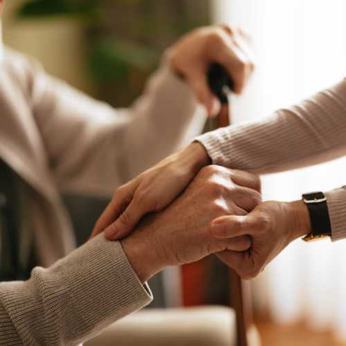 Caregiver holding a resident's hands at The Residences at Thomas Circle in Washington, District of Columbia 