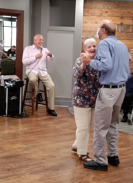 A charming Park Central couple takes to the dance floor while a local musician performs.