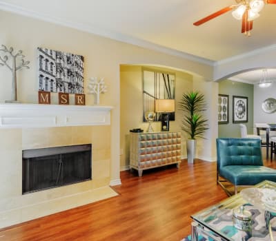 Open-concept floor plan with hardwood floors and ceiling fan in model home at Meritage at Steiner Ranch in Austin, Texas