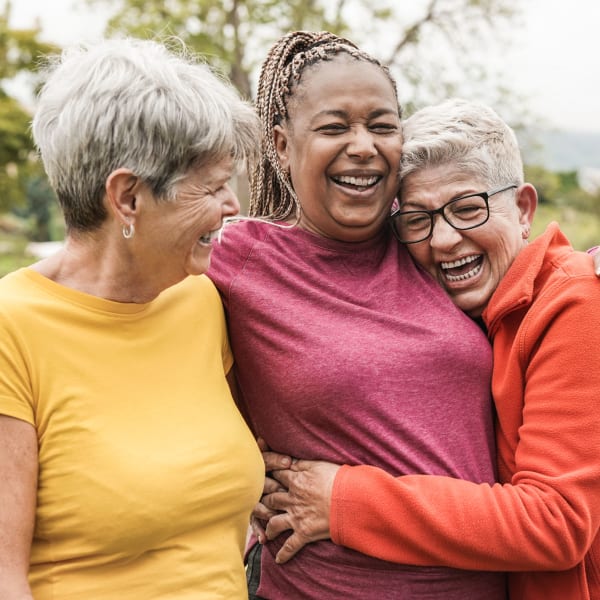 Group of residents embracing at Pacifica Senior Living Northridge in Northridge, California