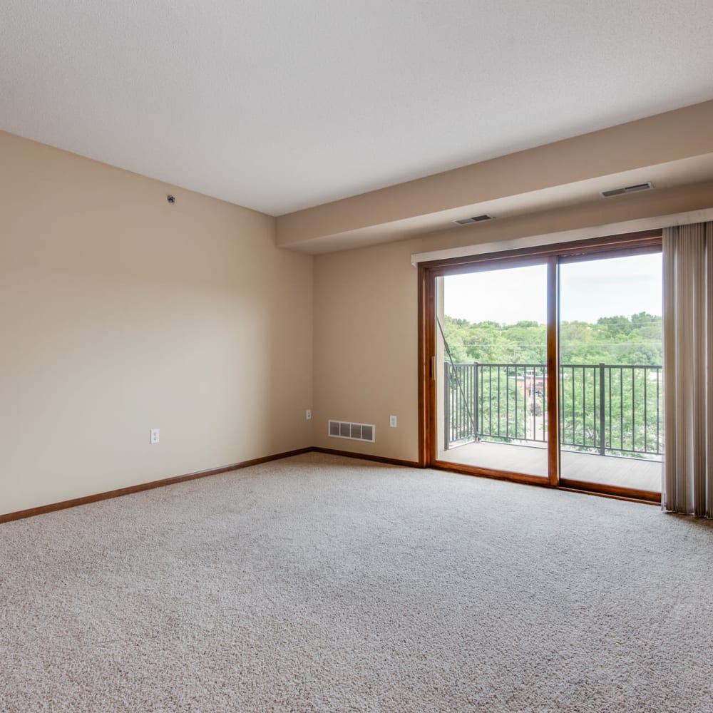 Spacious living area with plush carpeting in a model apartment at Oaks Glen Lake in Minnetonka, Minnesota