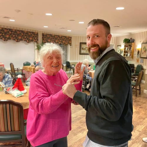 Caretaker showing off a bracelet made by a resident at Saddlebrook Oxford Memory Care in Frisco, Texas